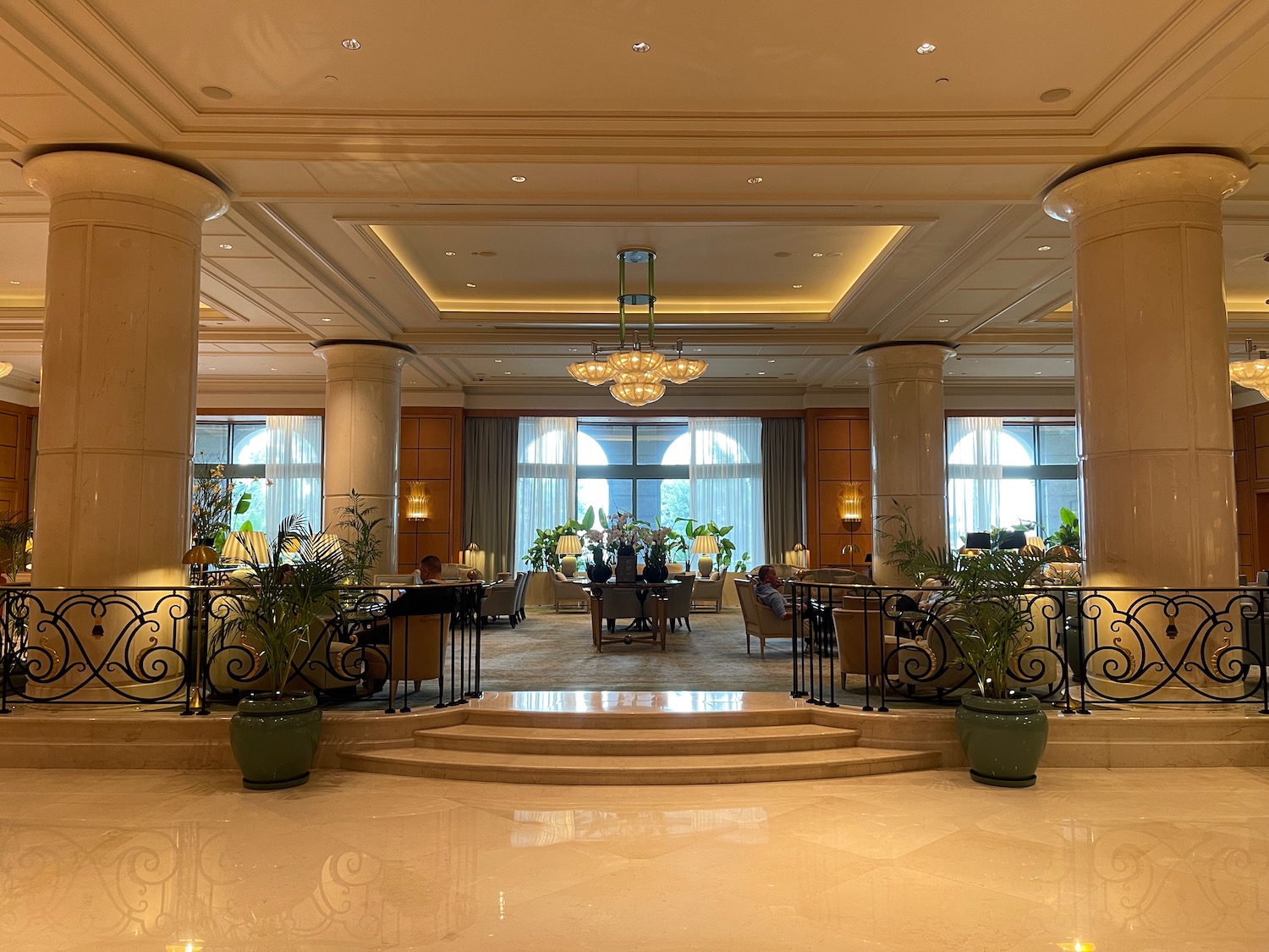 a large room with columns and a large chandelier