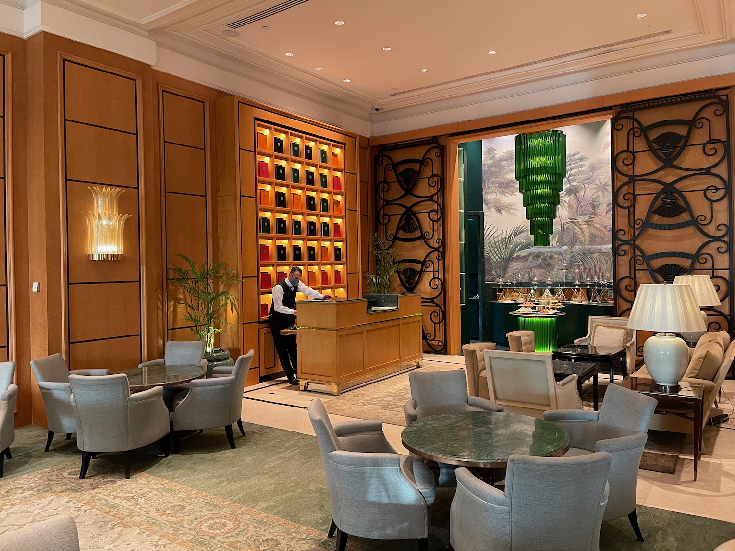 a man standing at a desk in a hotel lobby