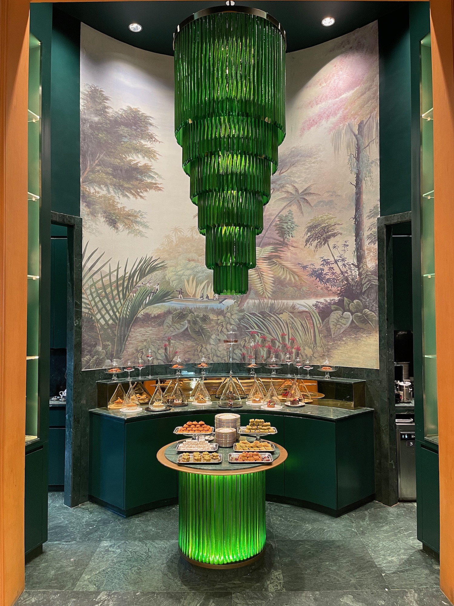 a green chandelier in a room with food on a table