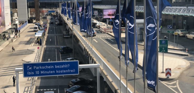 a street with flags and cars on it