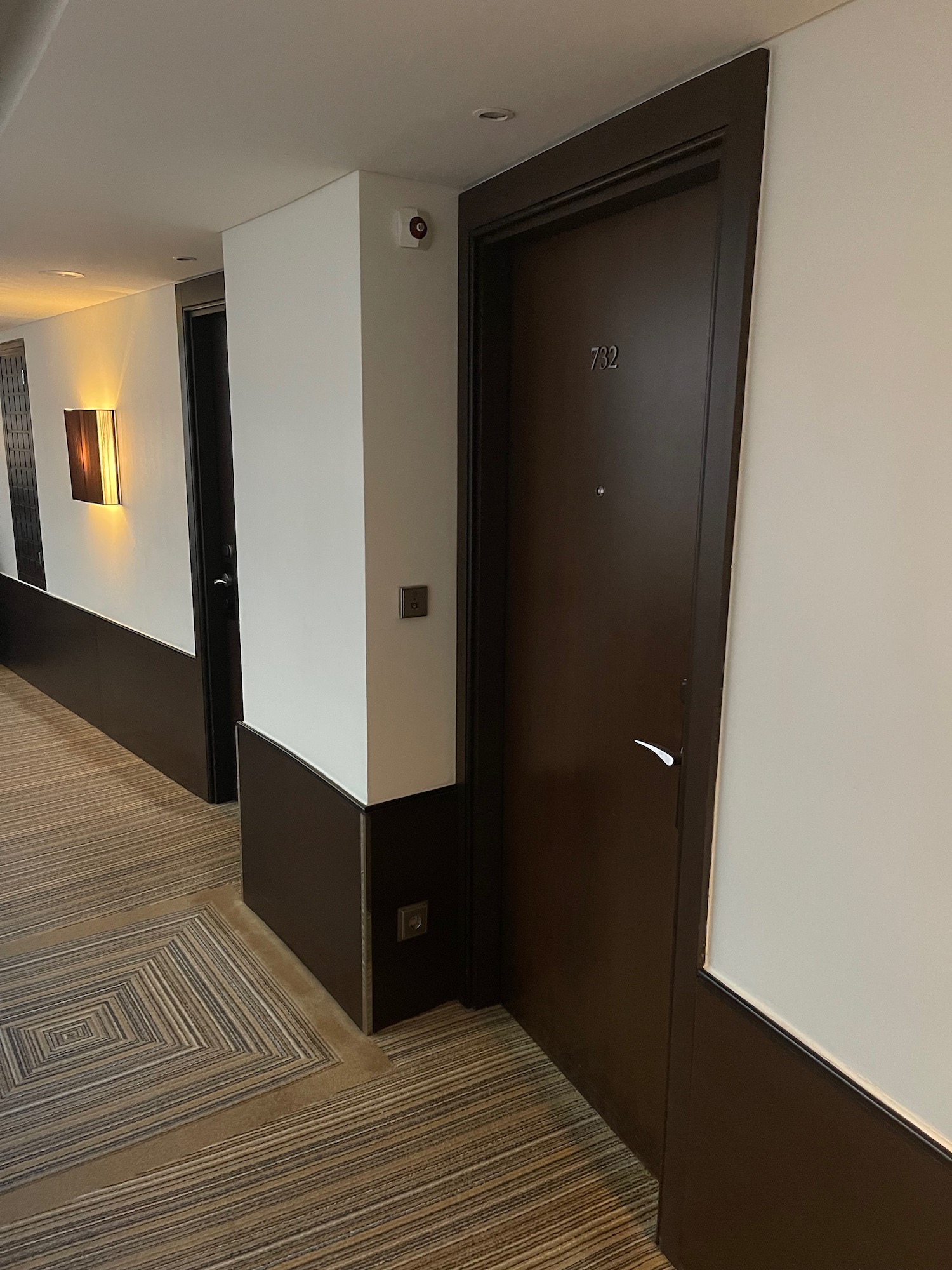 a hallway with brown doors and white walls