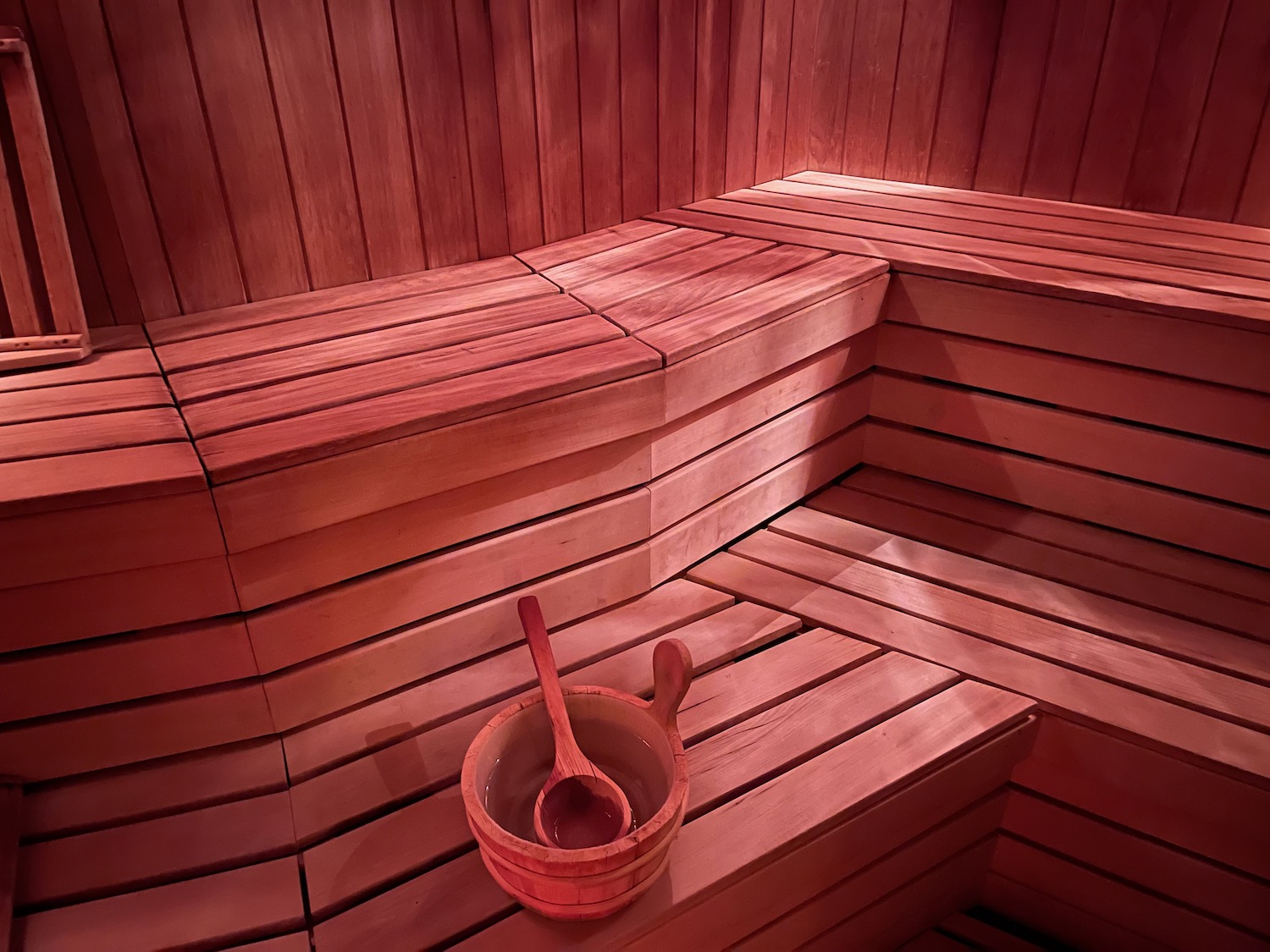 a wooden bowl and spoon on a bench