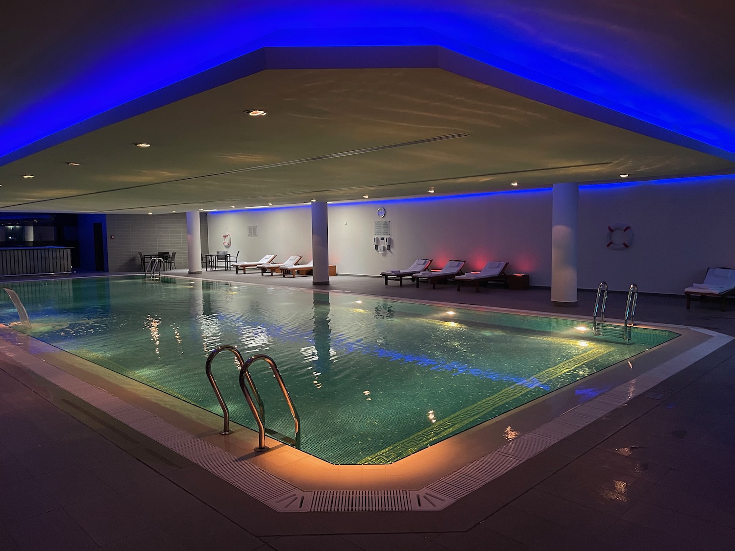 a indoor pool with a blue light