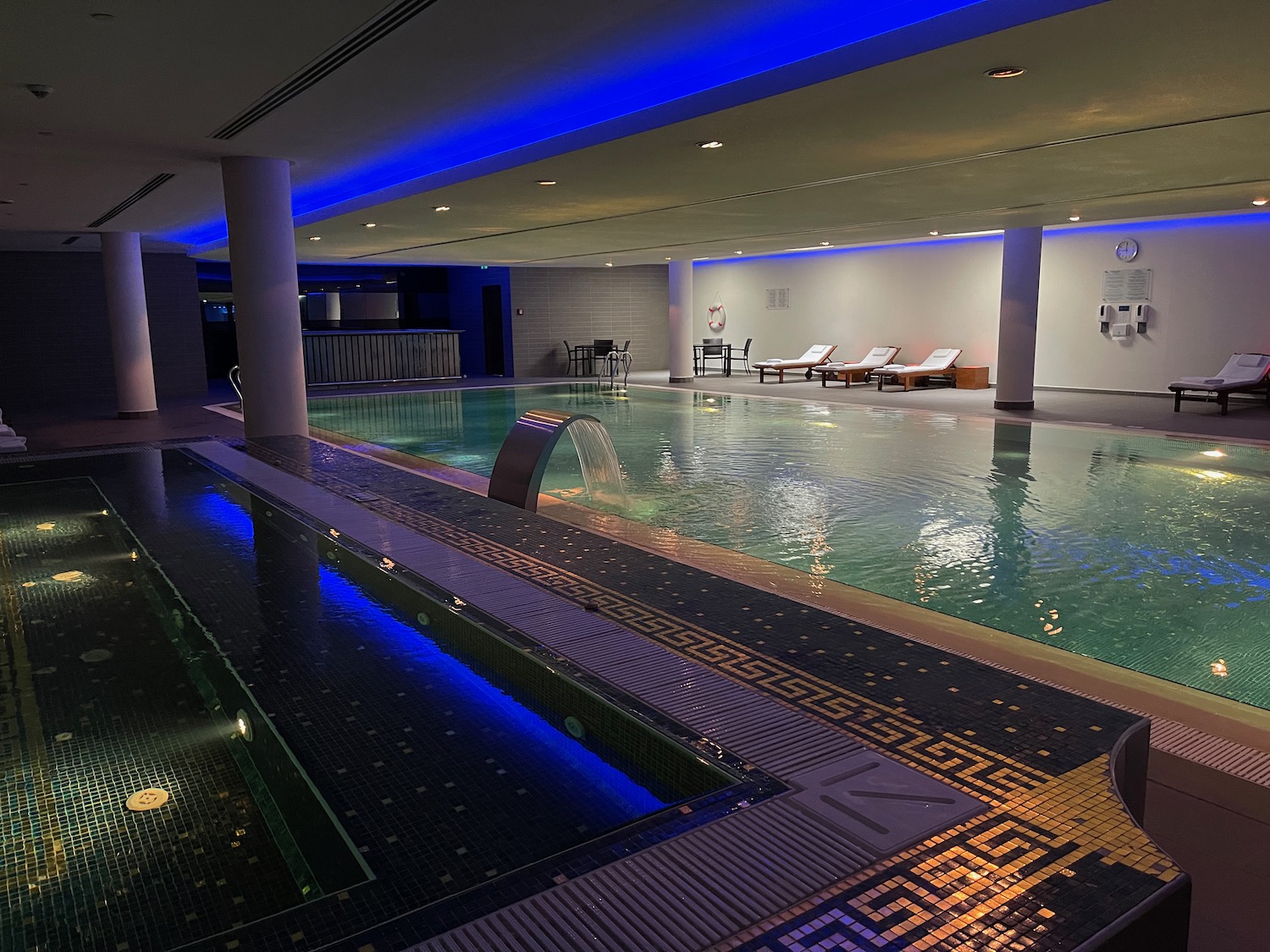 a indoor pool with a waterfall