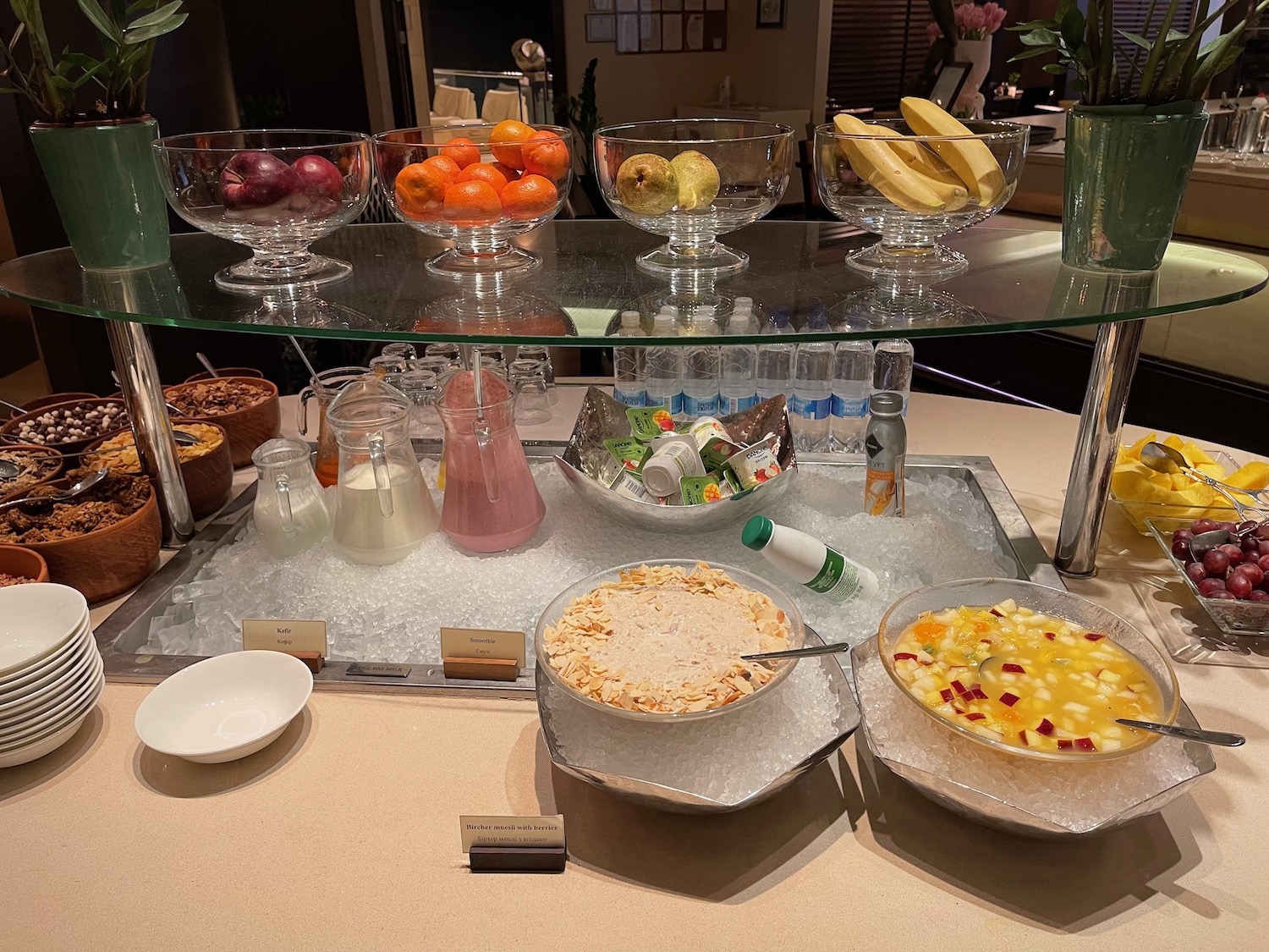 a buffet with bowls of food and drinks on a table