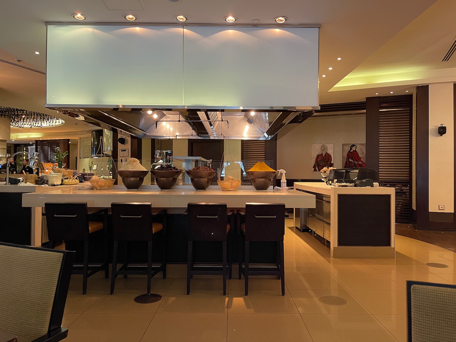 a kitchen with a large counter and chairs