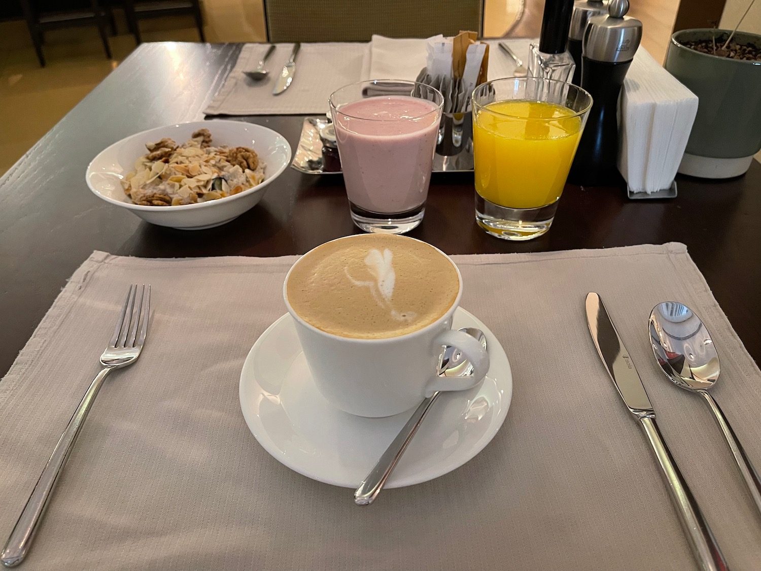 a table with a cup of coffee and cereals