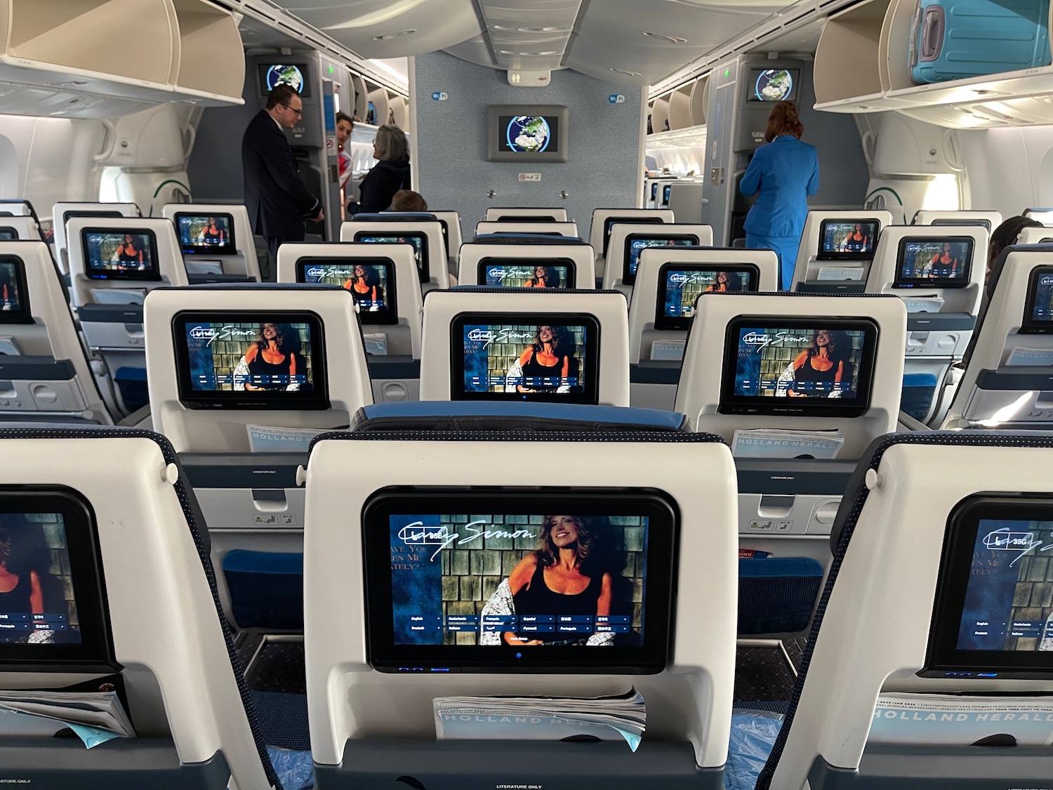 a row of seats with monitors on the back