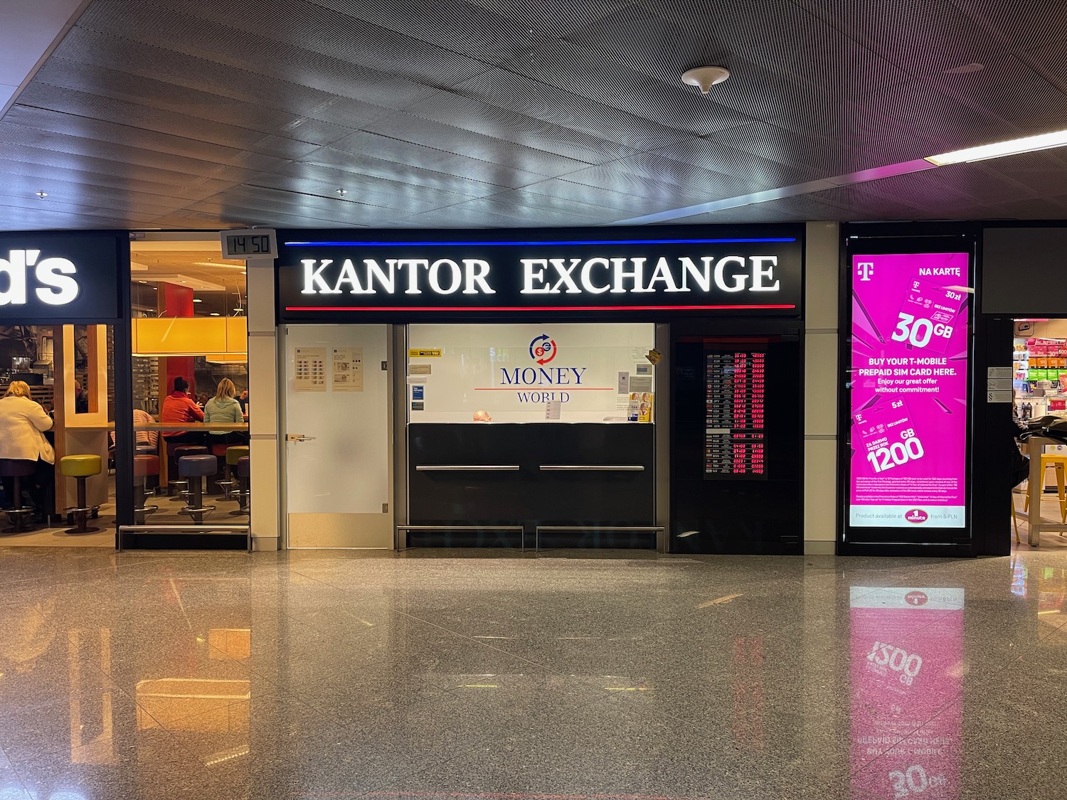 a building with a sign and a large screen