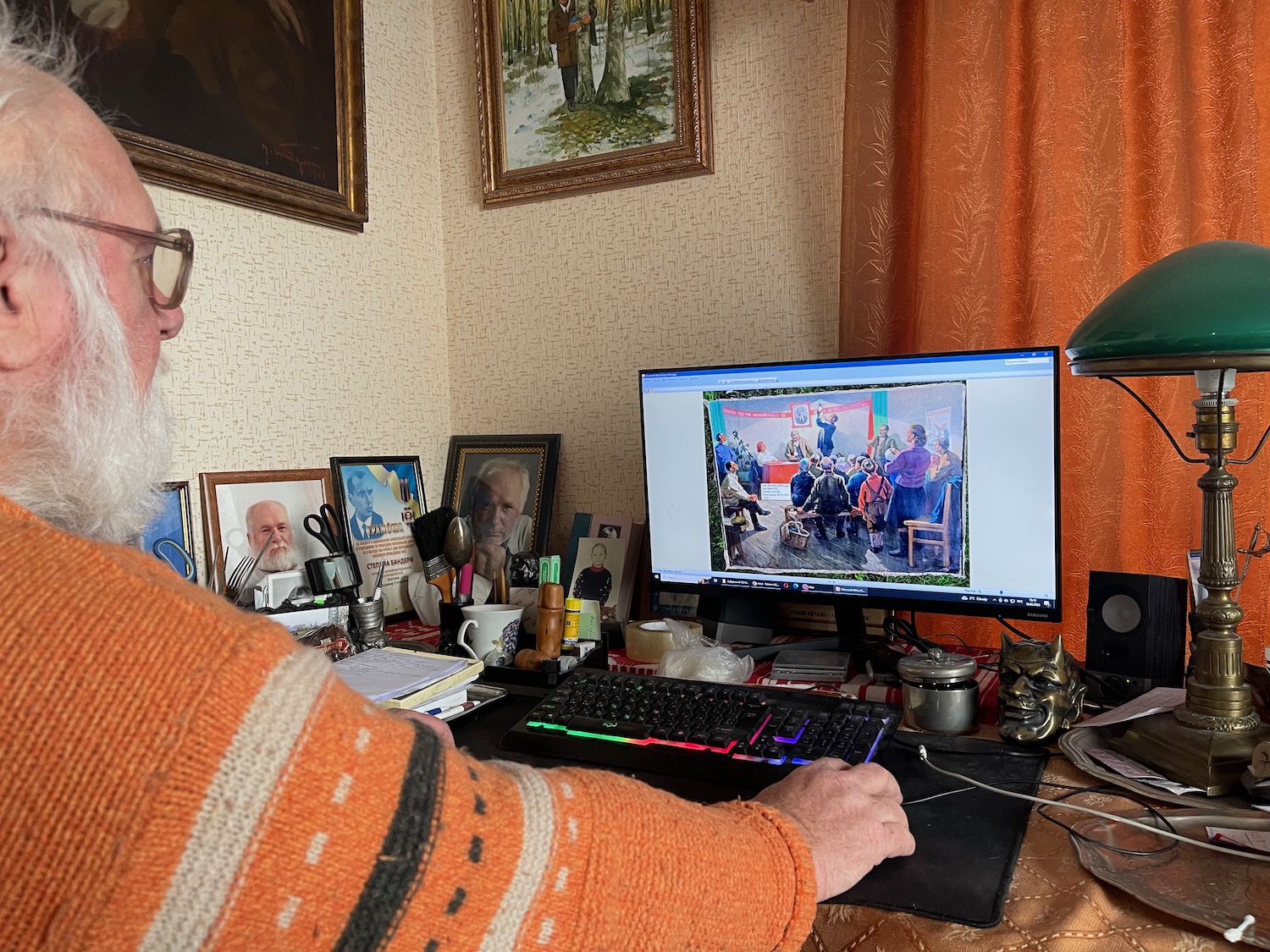 a man sitting at a desk with a computer