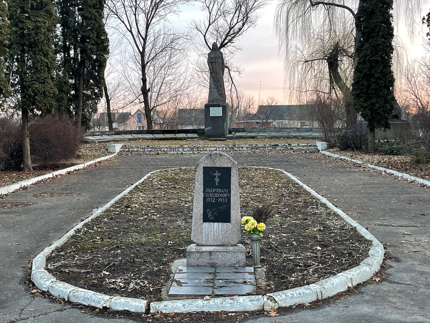 a grave stone with a cross and flowers in a circle