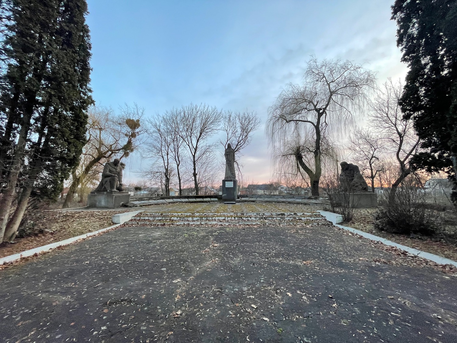 a stone statue in a park