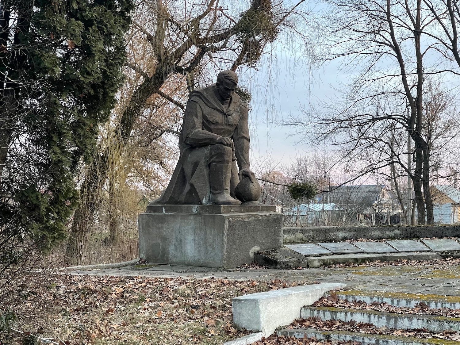 a statue of a man sitting on a pedestal