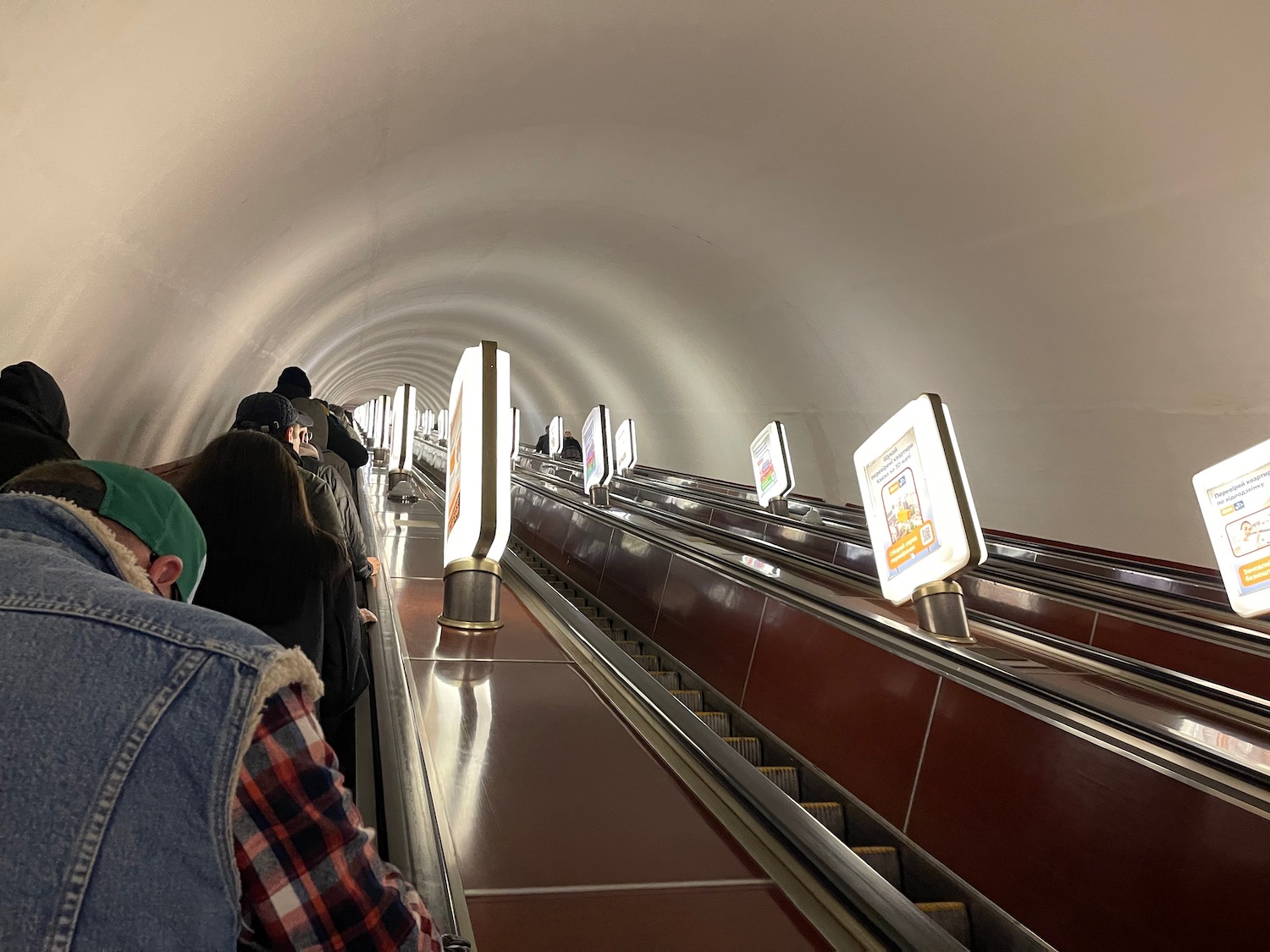 people standing on an escalator