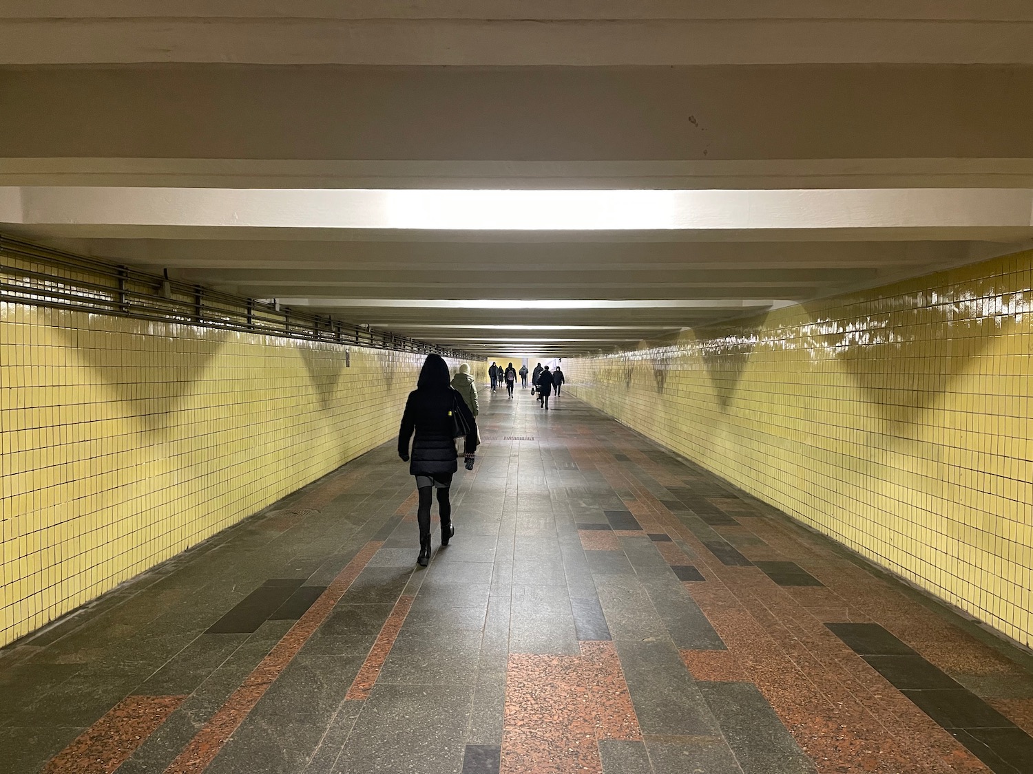 people walking in a tunnel
