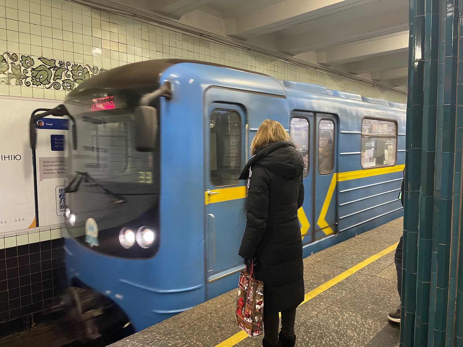 a woman standing at a train station