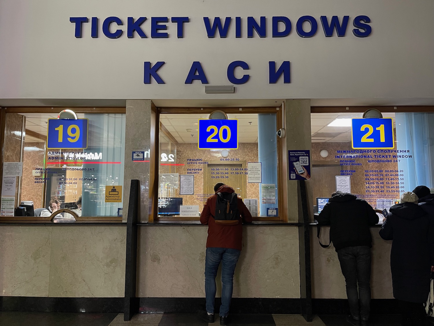 a person standing in front of a ticket window