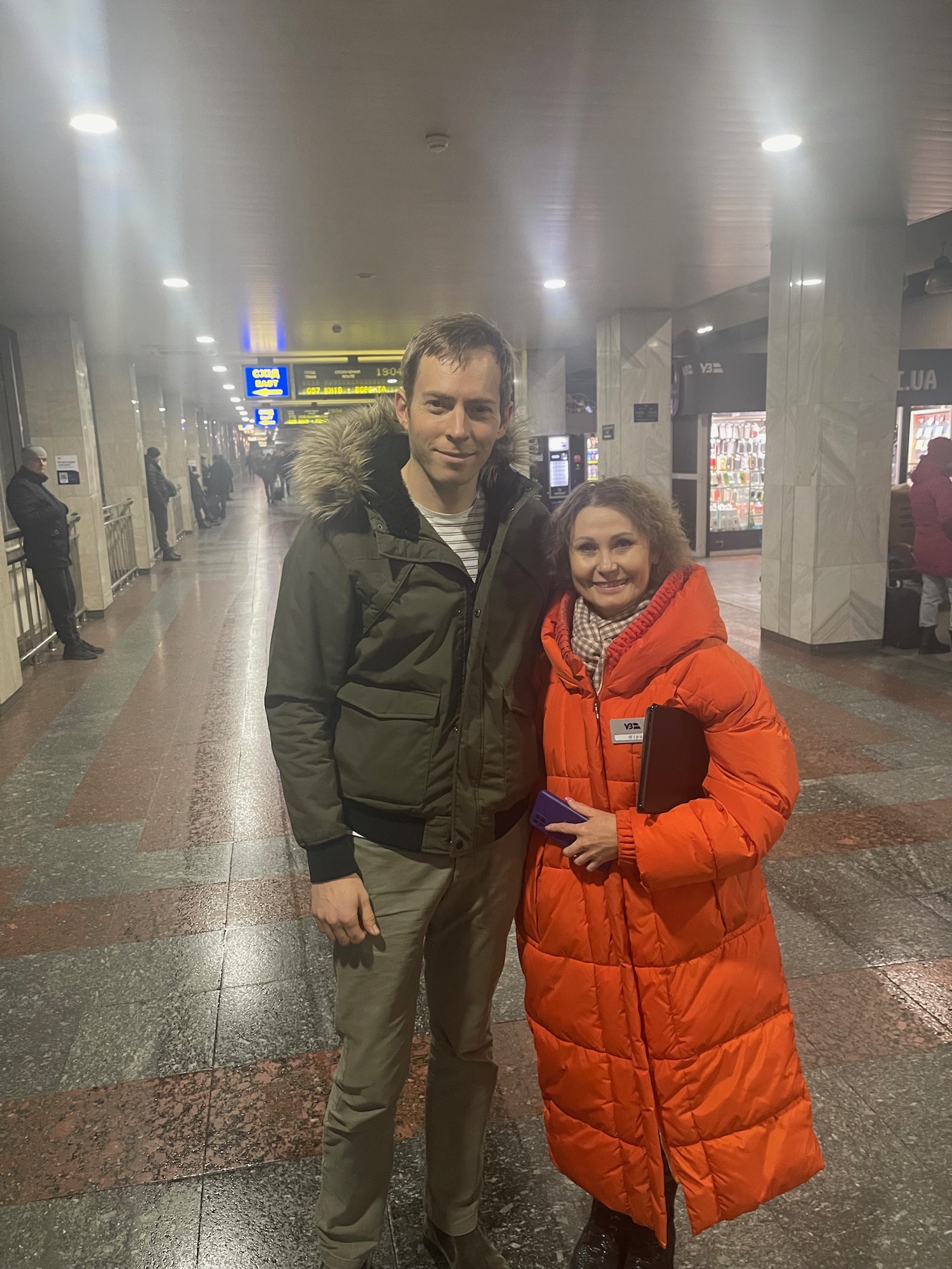 a man and woman standing in a hallway