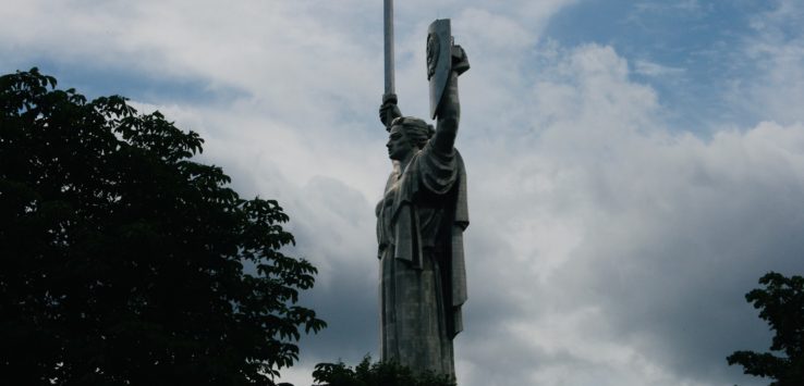 a large statue of a woman holding a shield and a shield