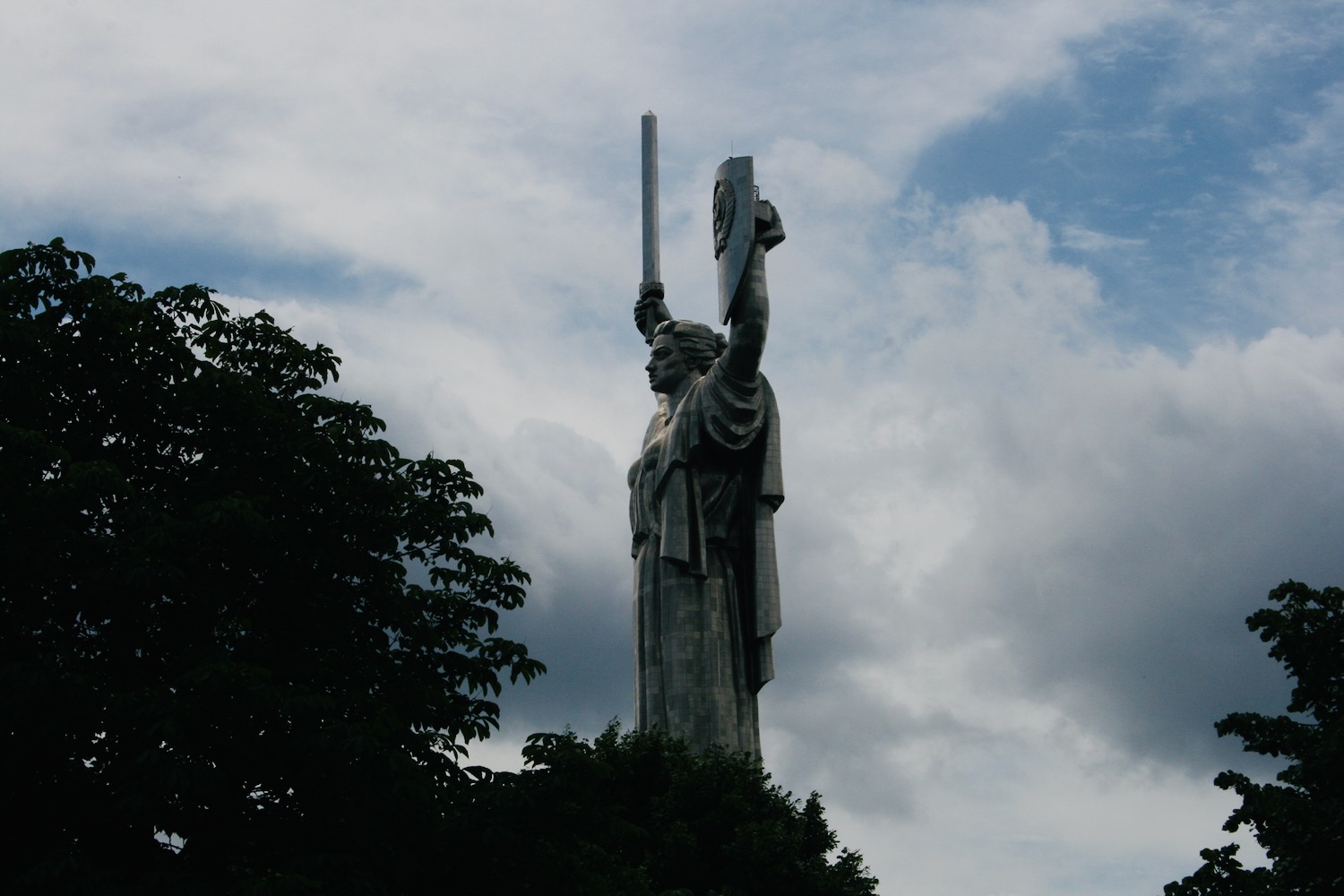 a large statue of a woman holding a shield and a shield