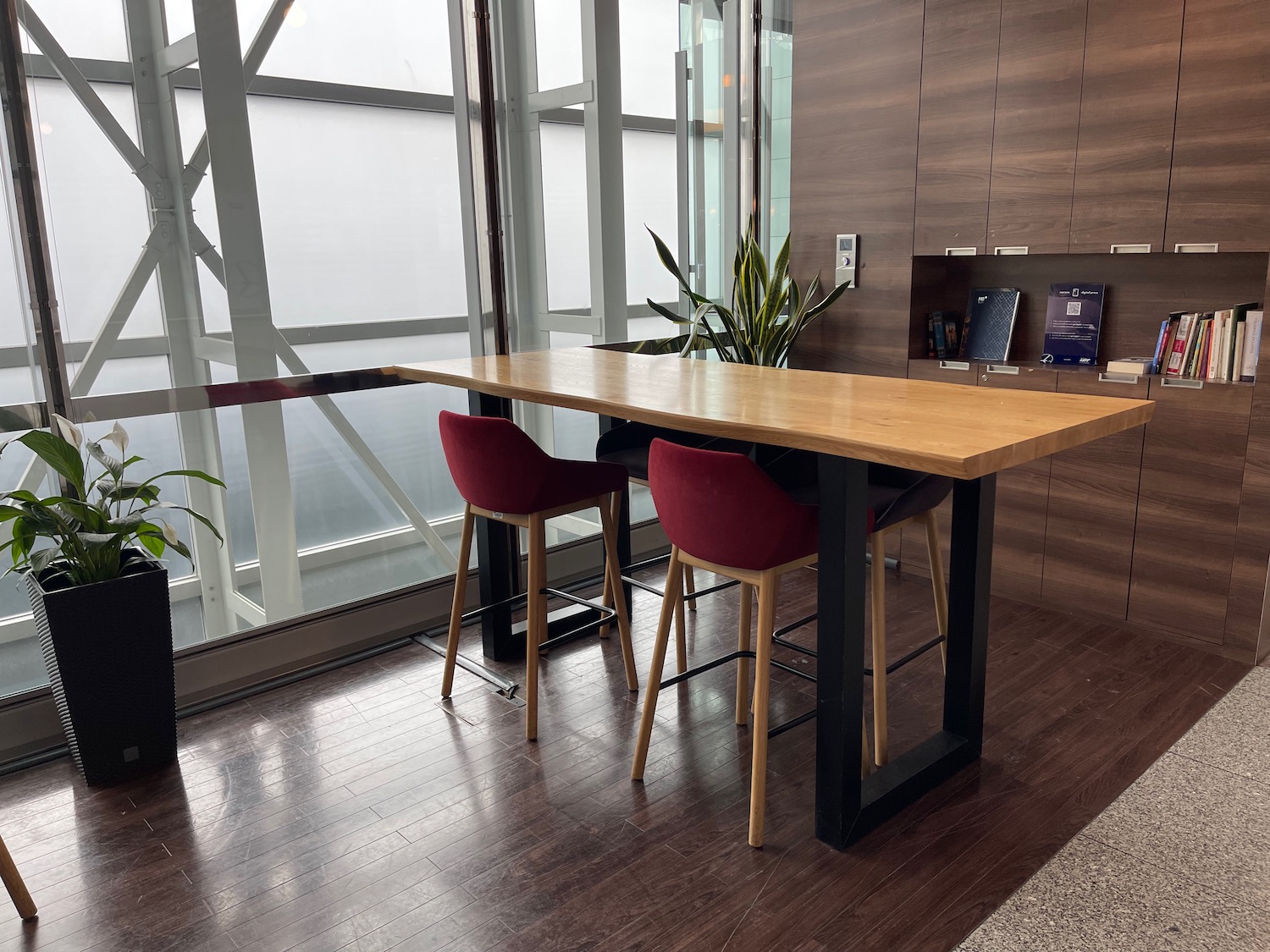 a table with chairs in a room with a window