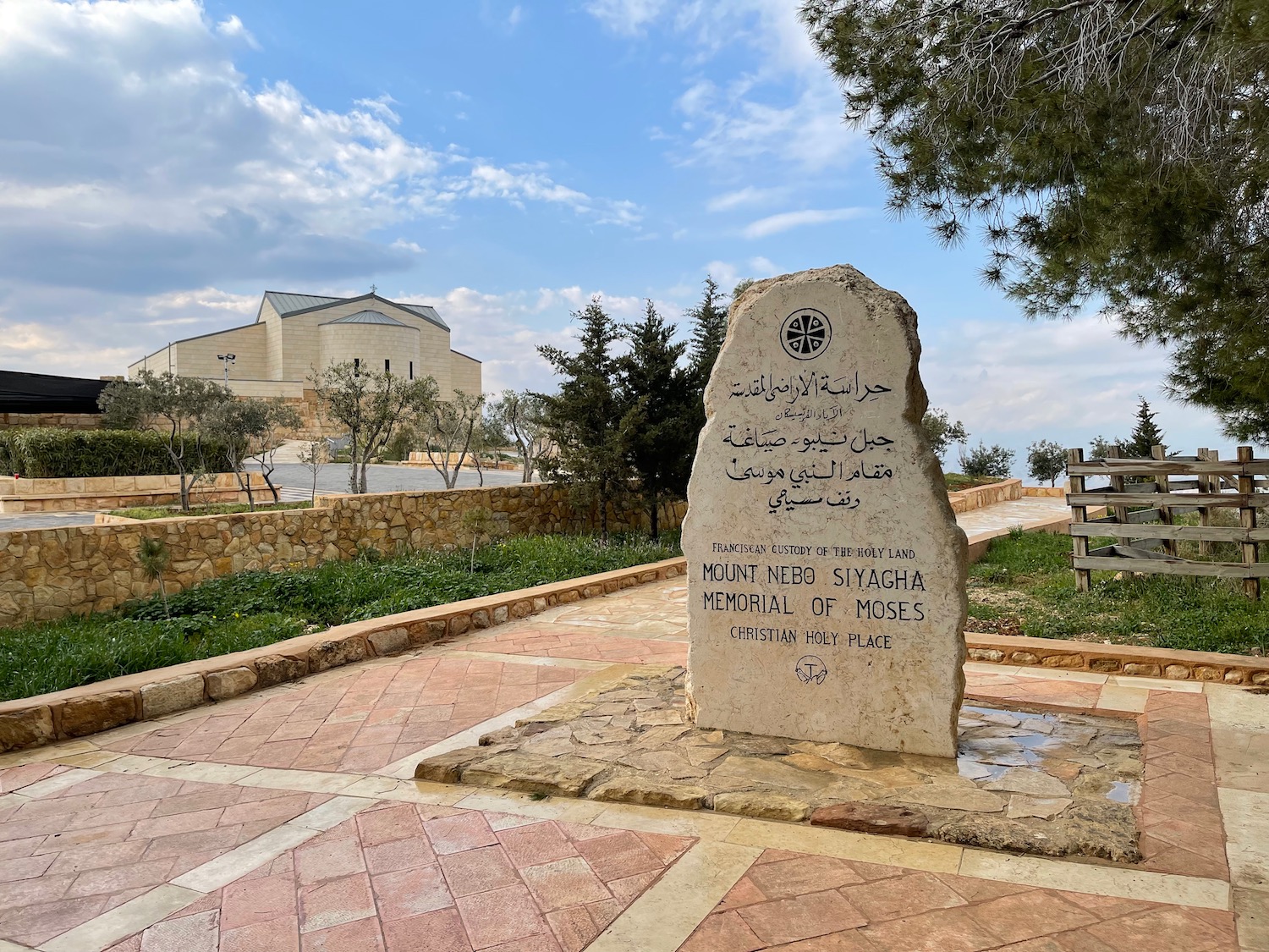 a stone monument with a building in the background