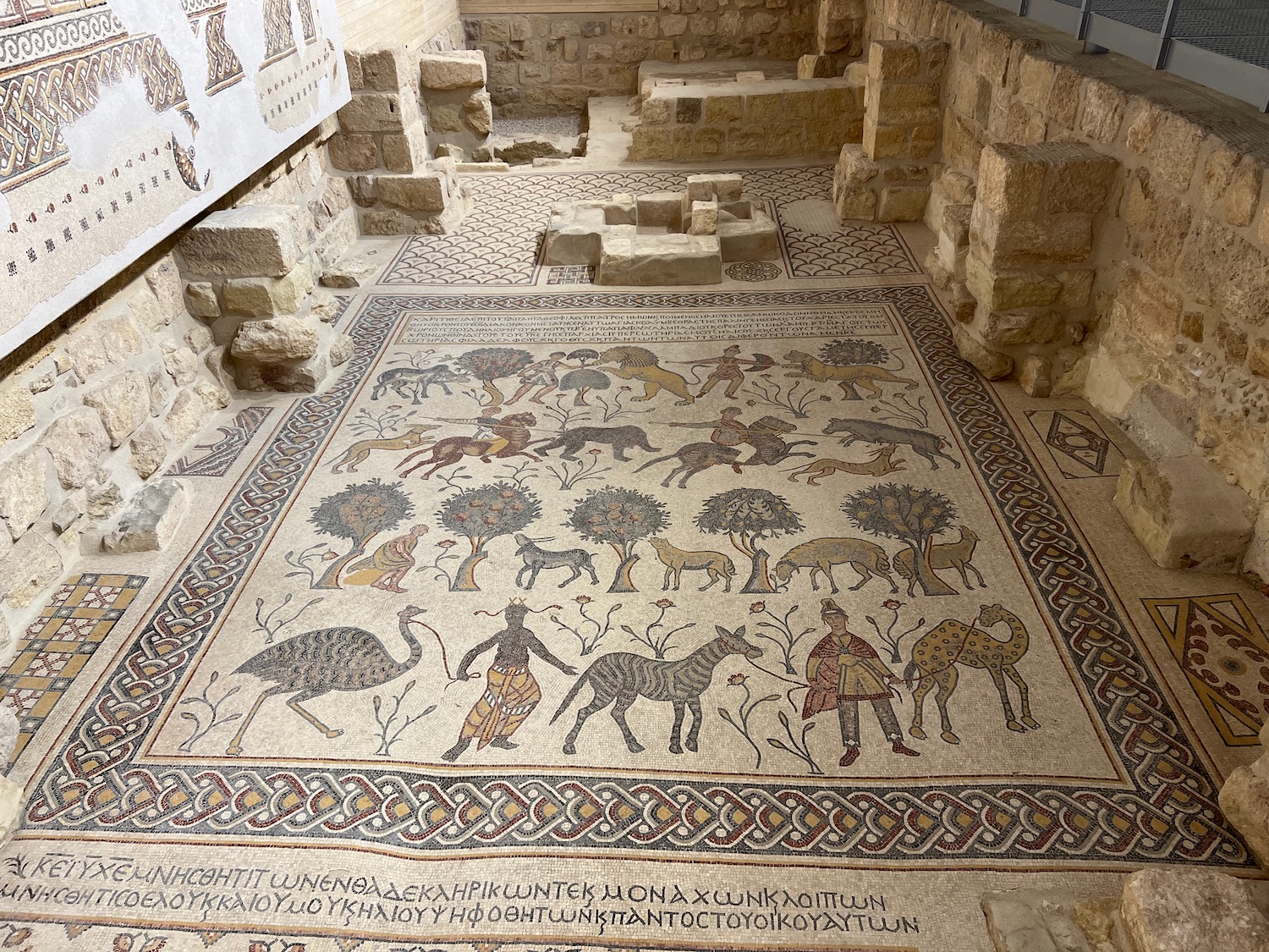 a mosaic floor with animals and birds on it