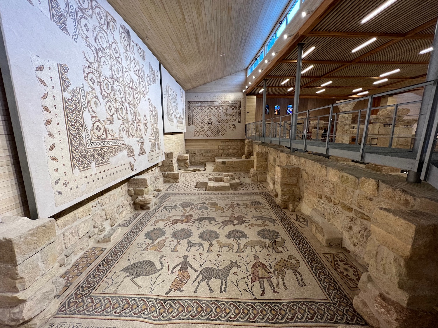 a stone floor with a mosaic floor and a railing