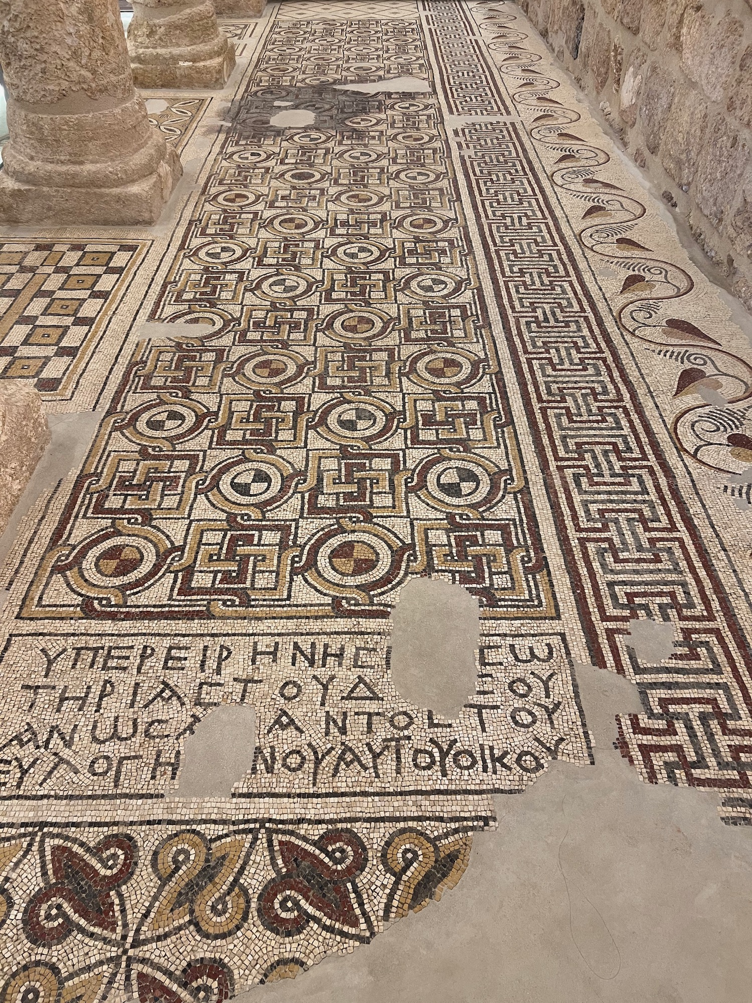 a mosaic floor with a hole in it