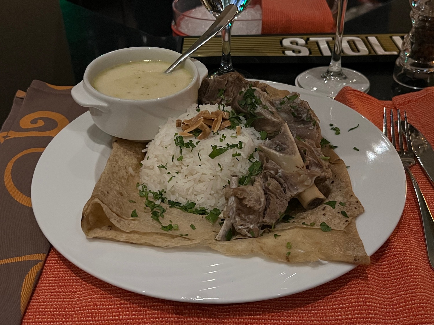 a plate of food with a bowl of soup and a glass of wine