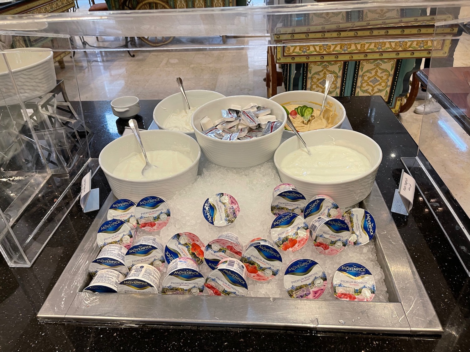 a group of bowls of yogurt and yogurt on ice