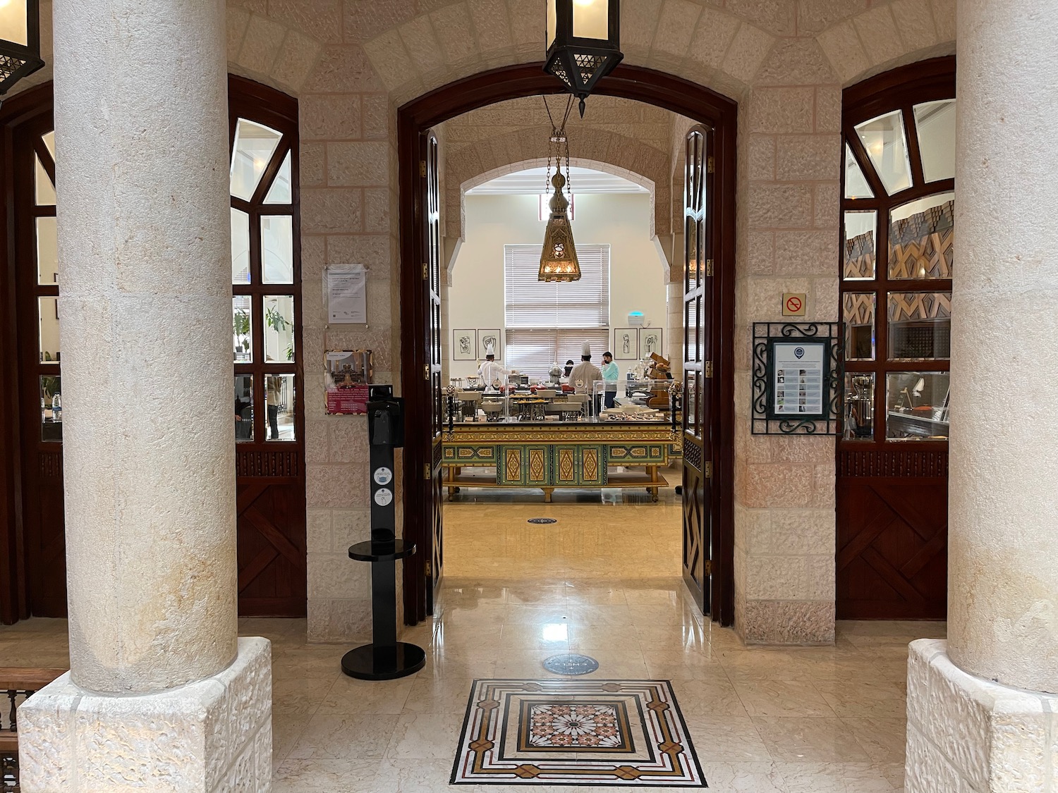 a hallway with a large doorway and a large table