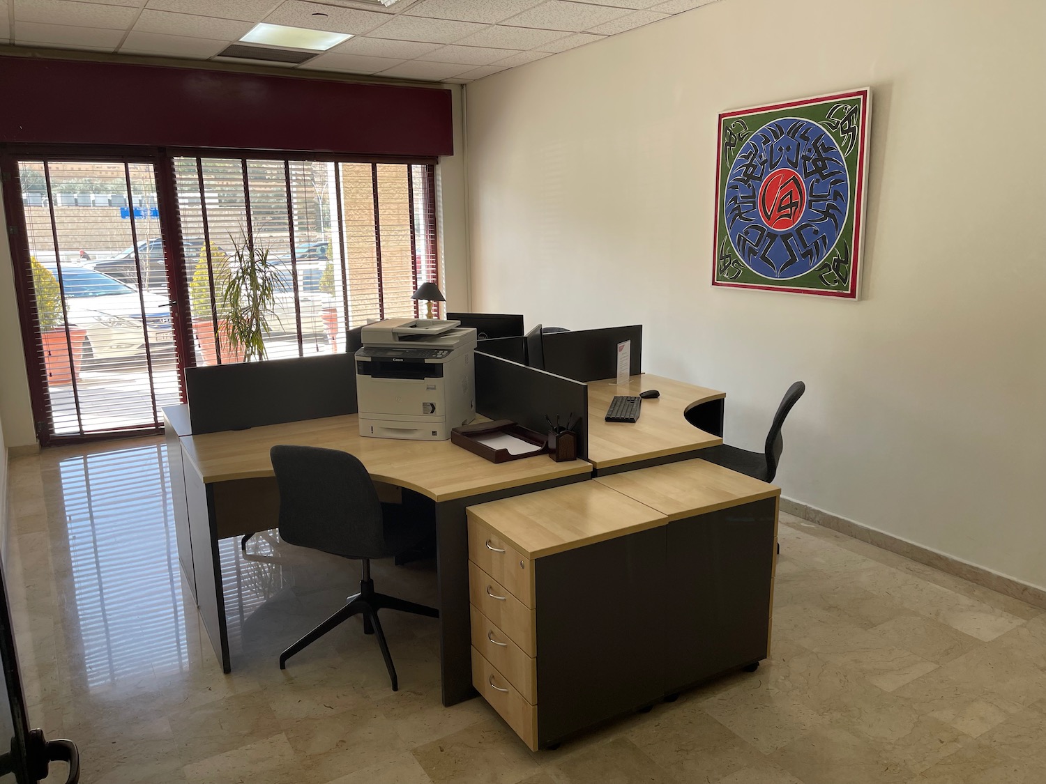 a desk with a printer and chair in a room