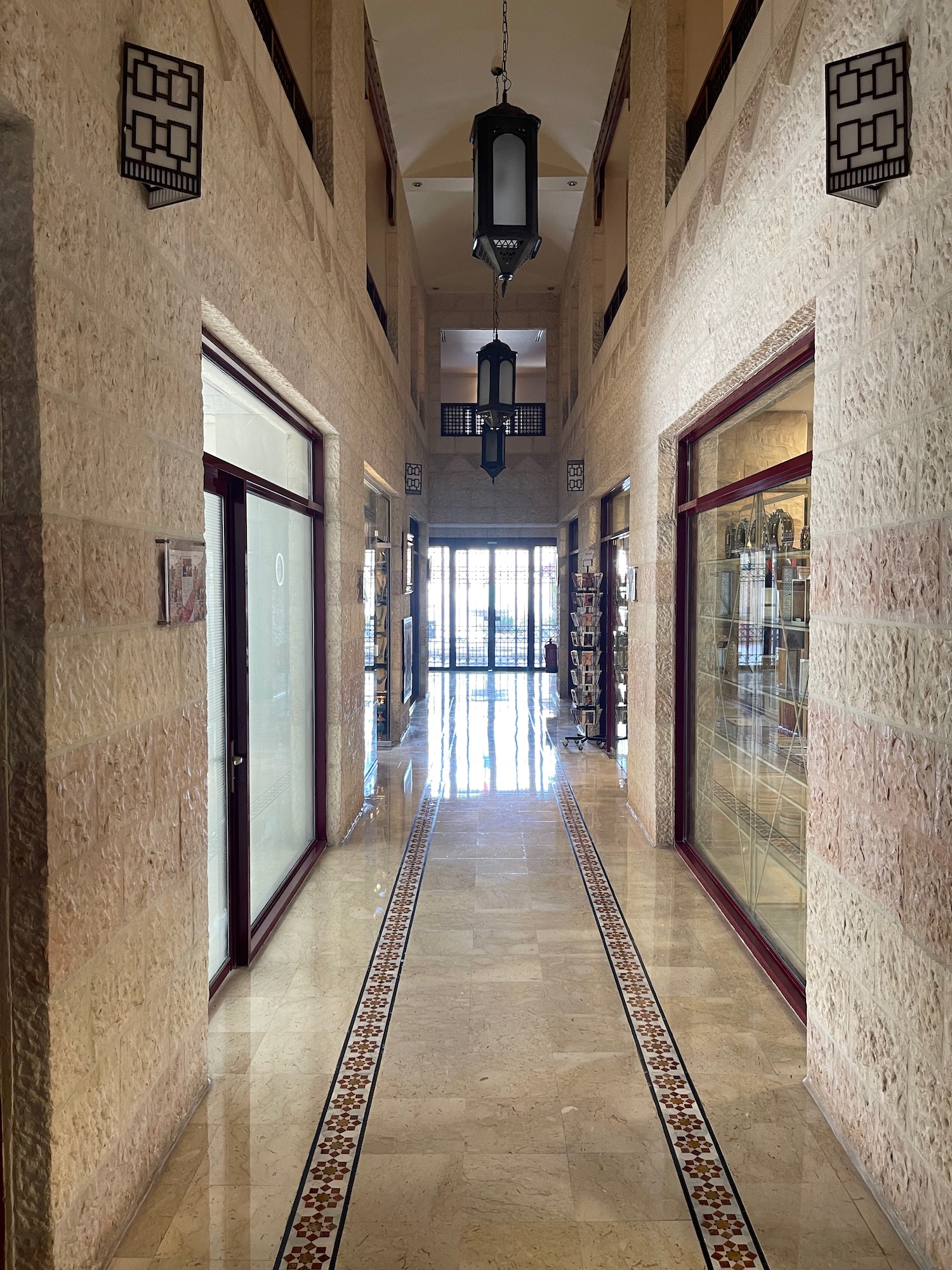 a hallway with glass doors and a glass door