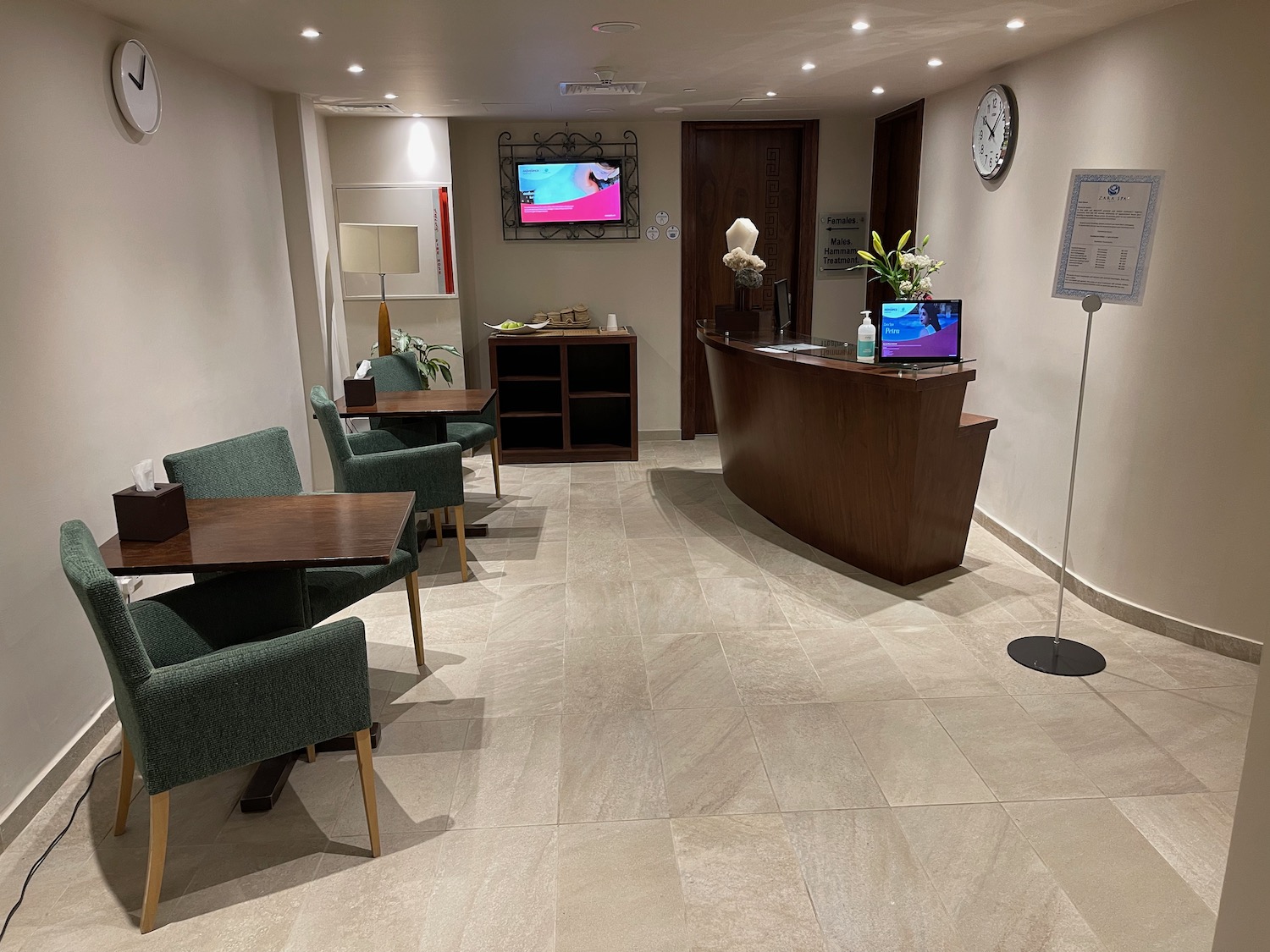 a reception desk and chairs in a hotel