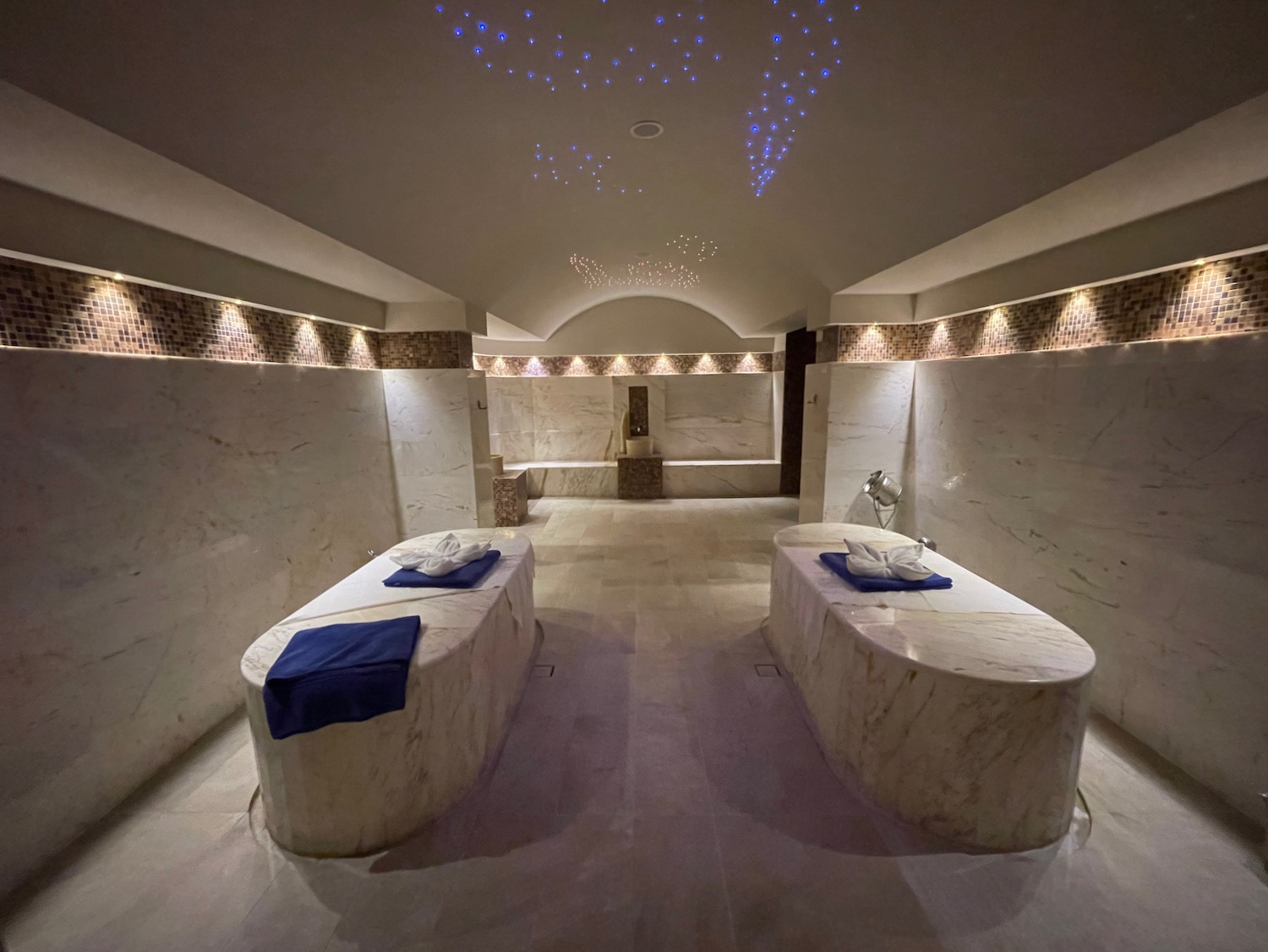 a room with marble walls and lights