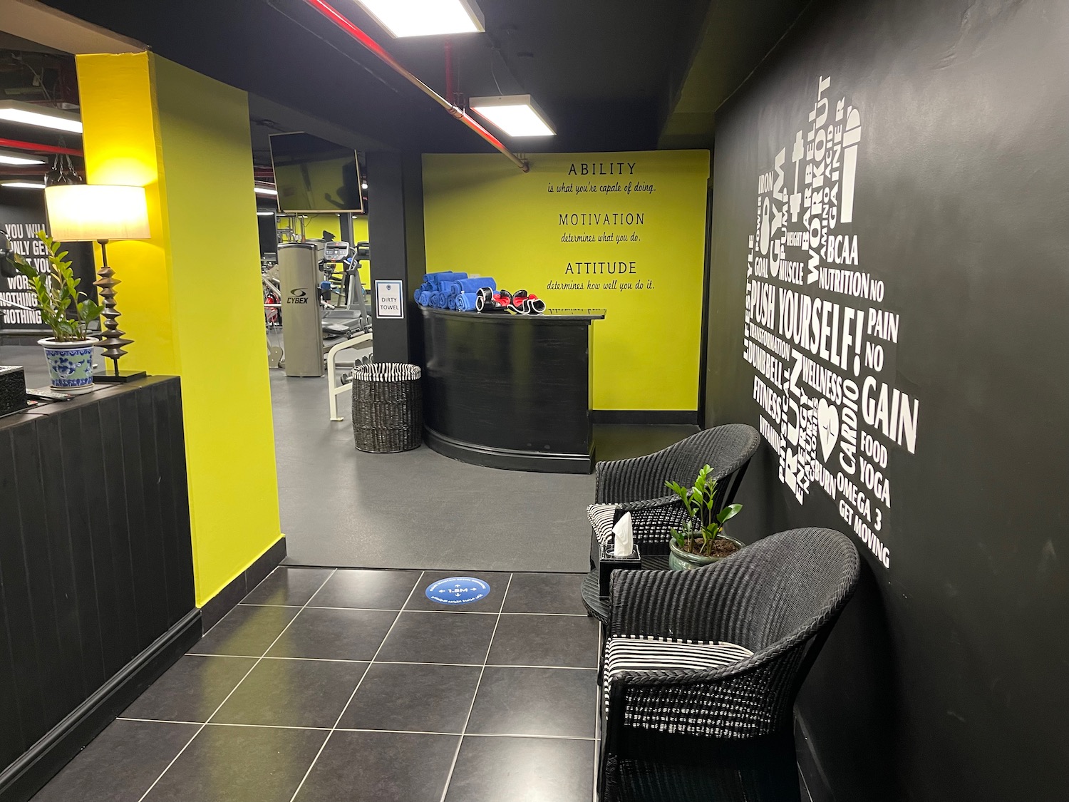 a room with a black tile floor and a black counter and chairs