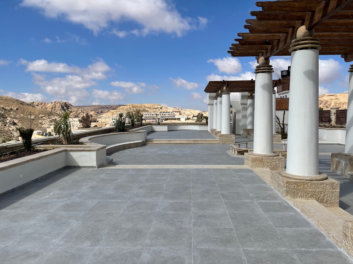 a building with pillars and a stone walkway