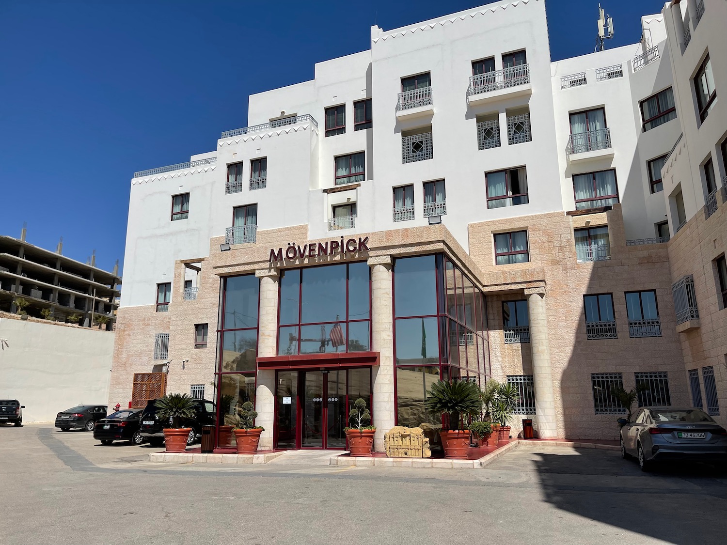 a building with glass windows and a parking lot