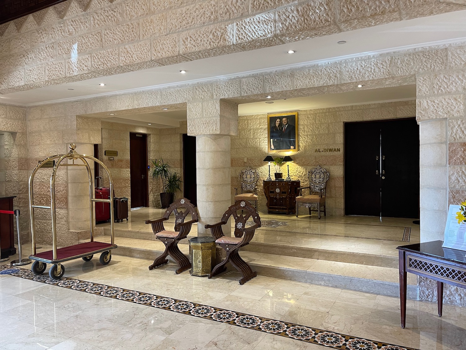 a hotel lobby with a cart and chairs