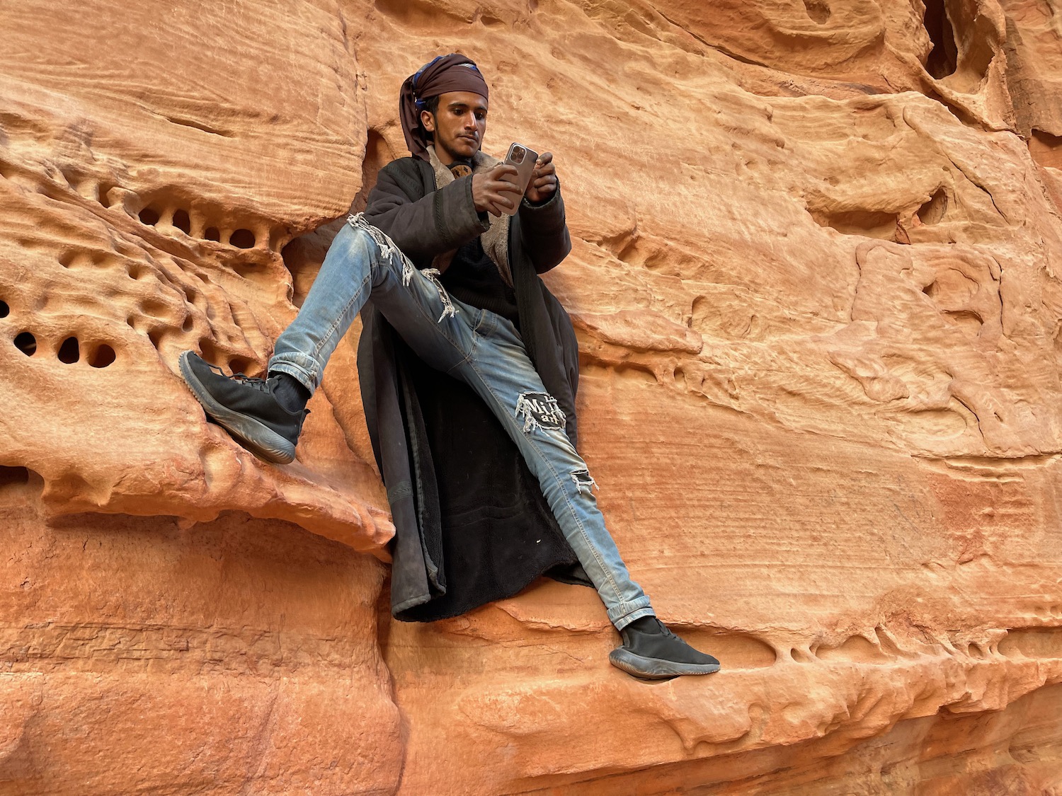 a man sitting on a rock