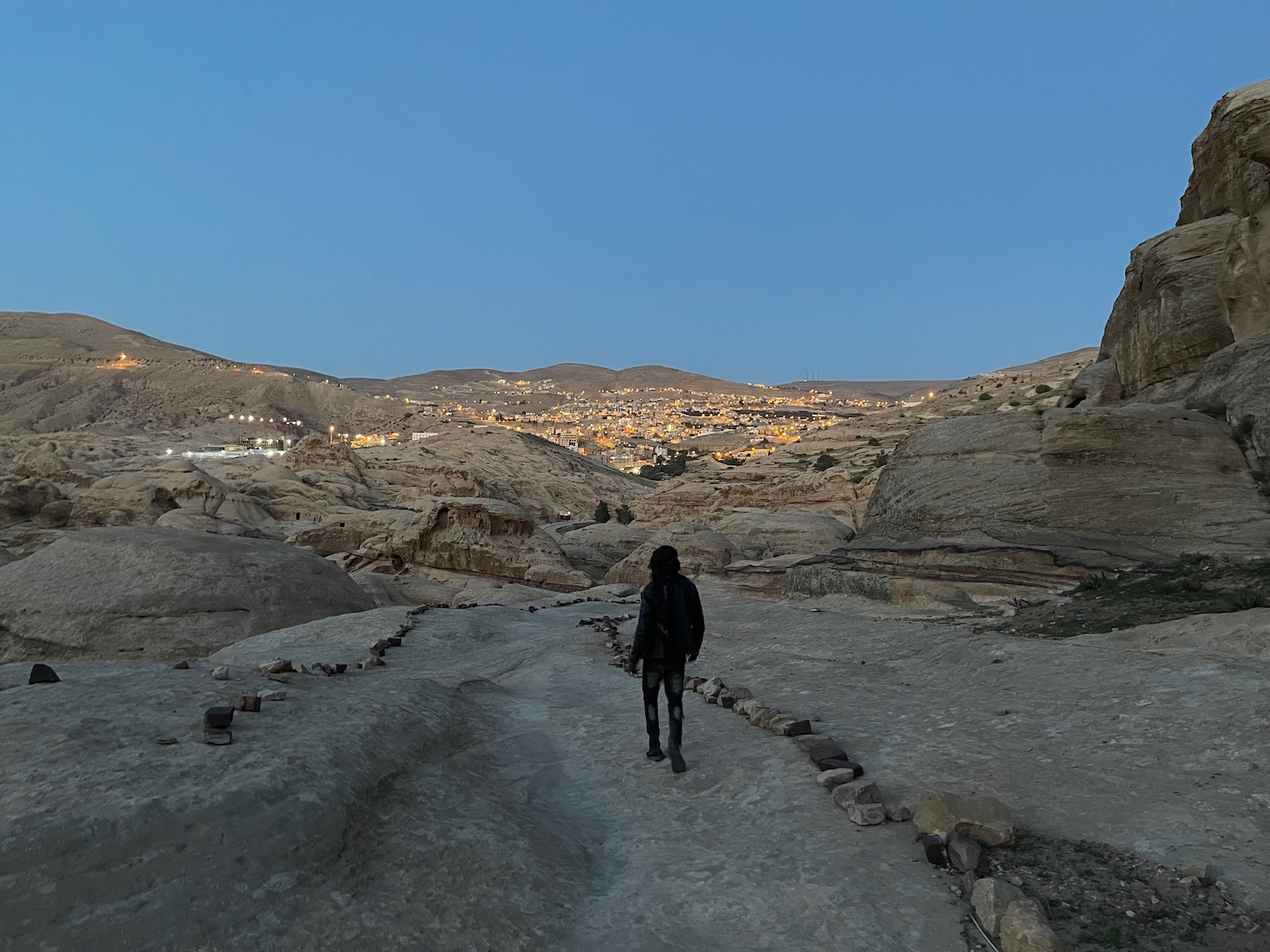 a person walking on a path in a desert