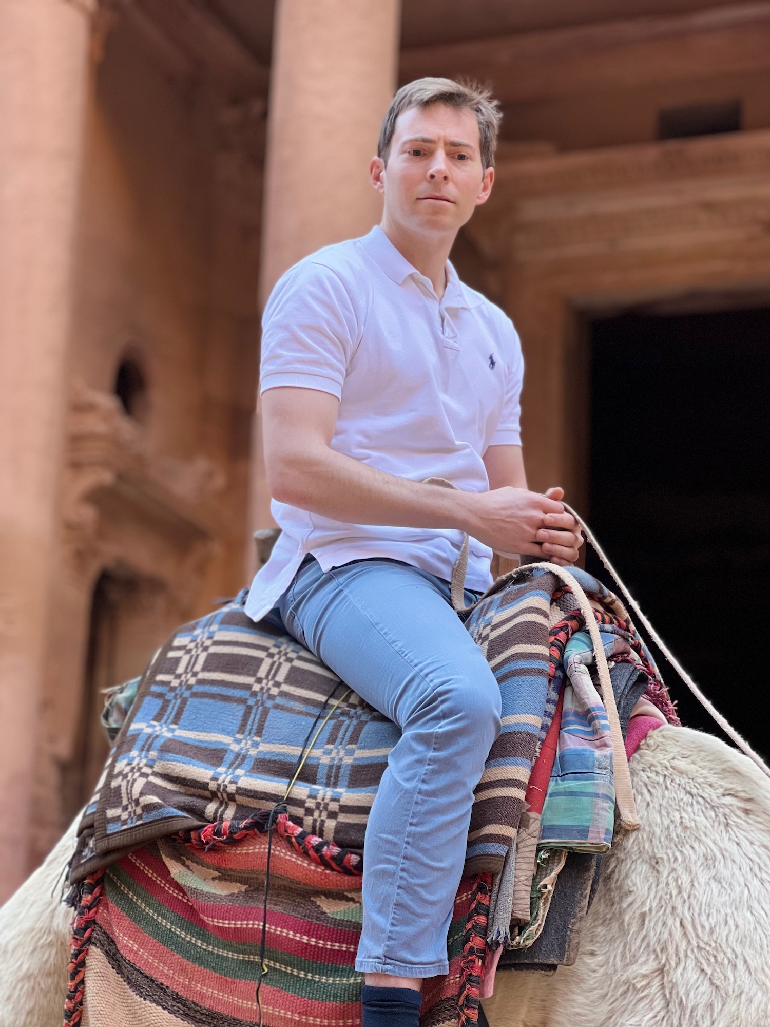 a man sitting on a camel