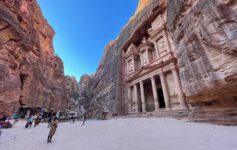 a group of people walking in a canyon