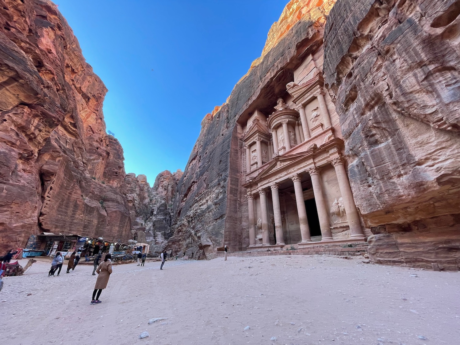 a group of people walking in a canyon