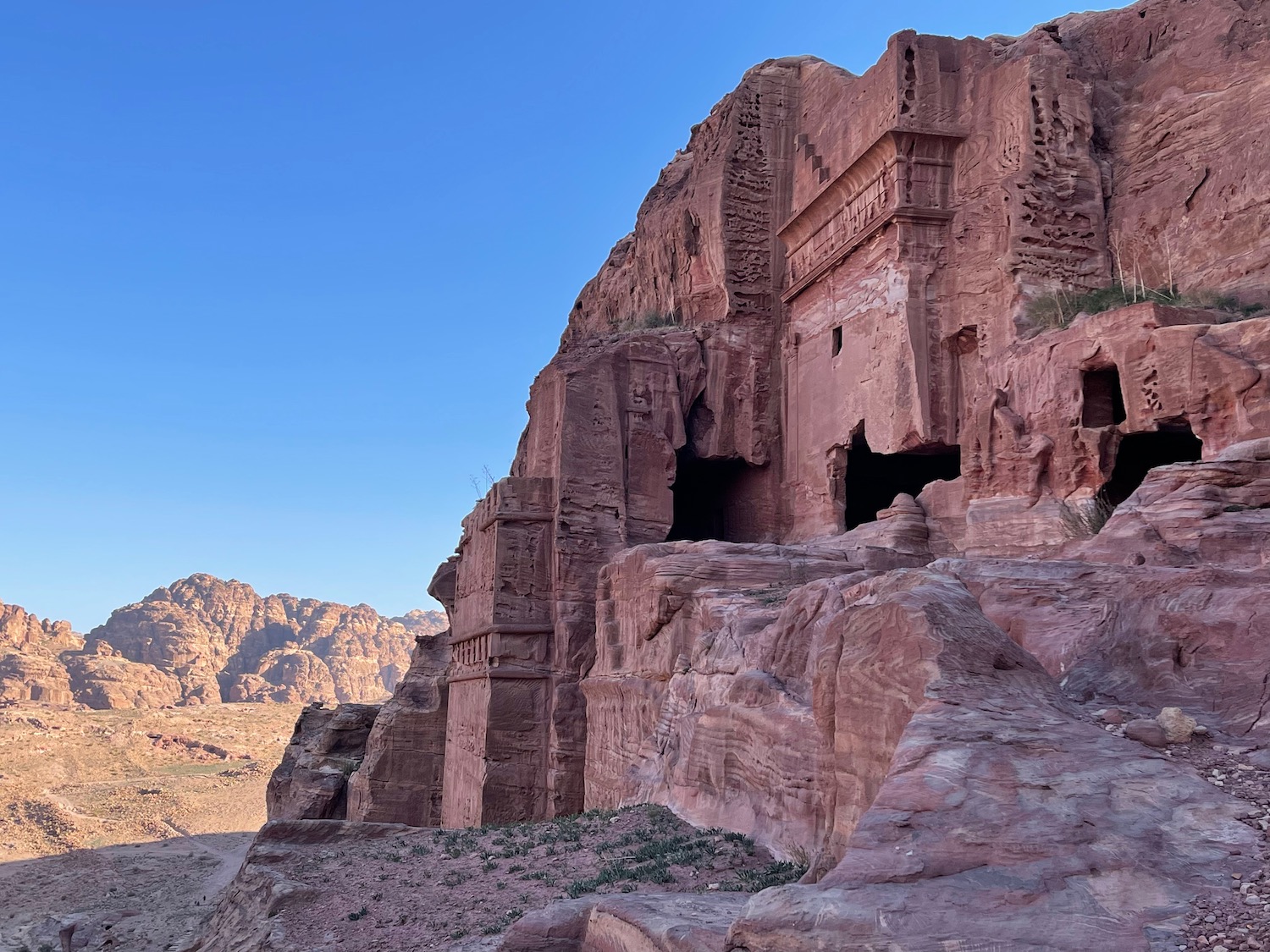 a rock cliff with a cave in the middle