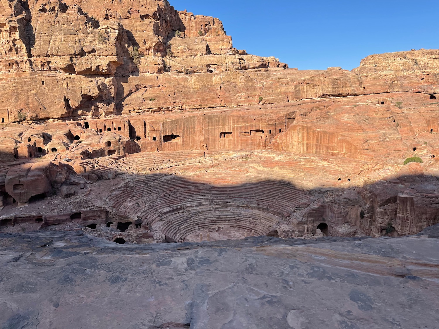 a large red rock canyon with a circular amphitheater