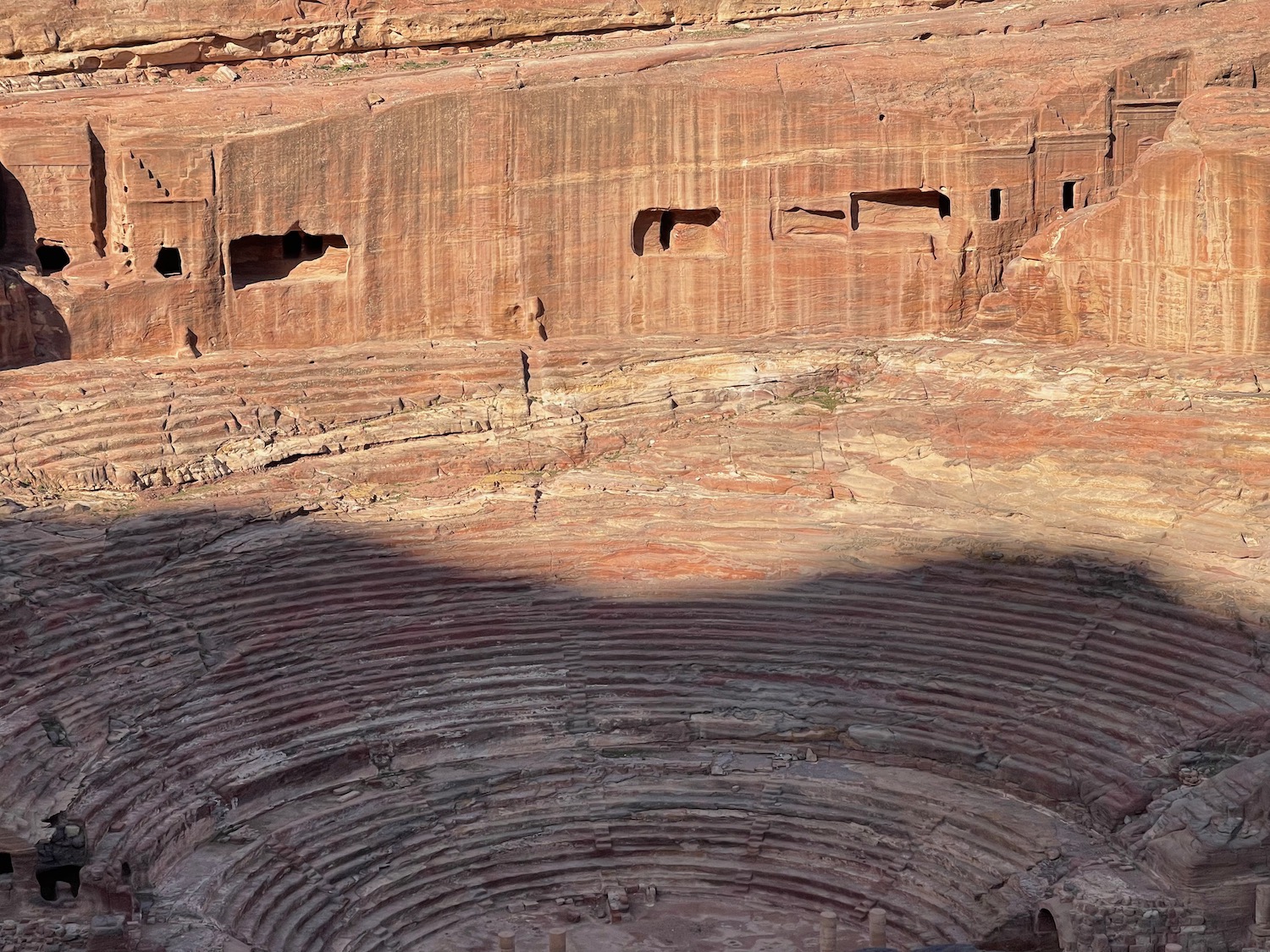 a circular stone structure with many holes in the side