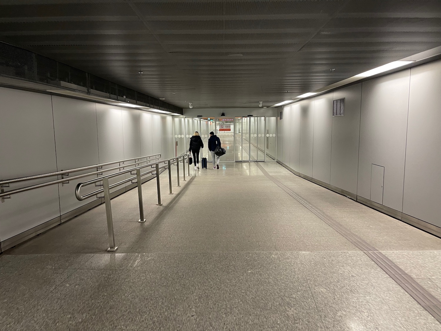 people walking in a tunnel