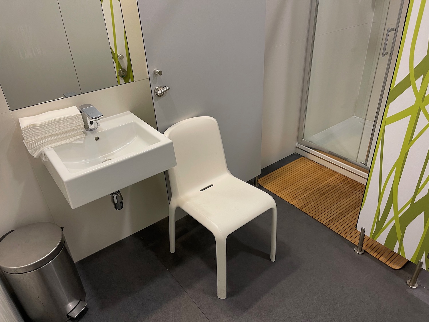 a bathroom with a sink and a chair